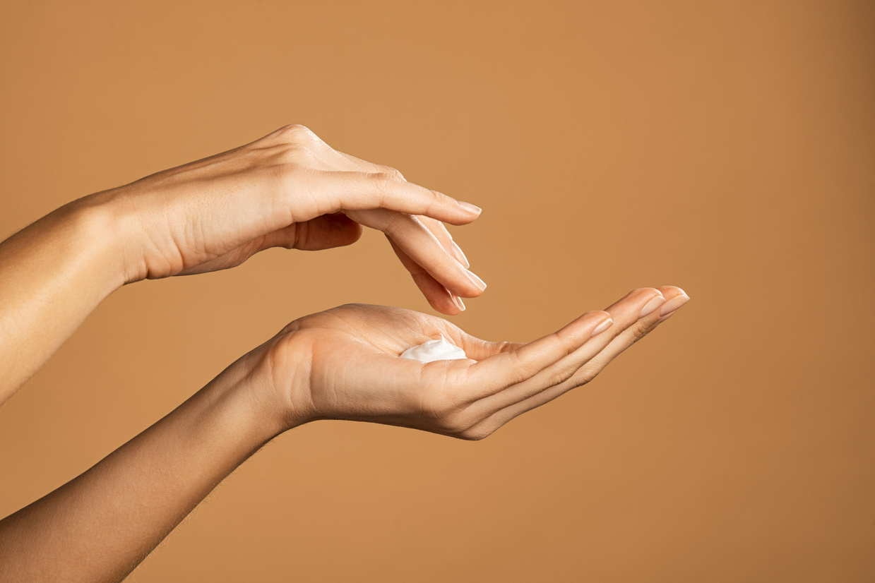 Woman Hand Applying Lotion Cream